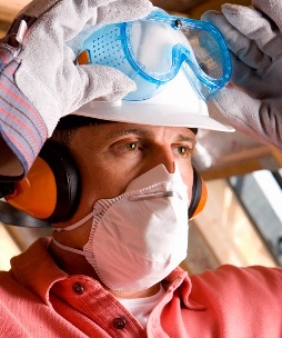 man wearing mask and putting on safety goggles